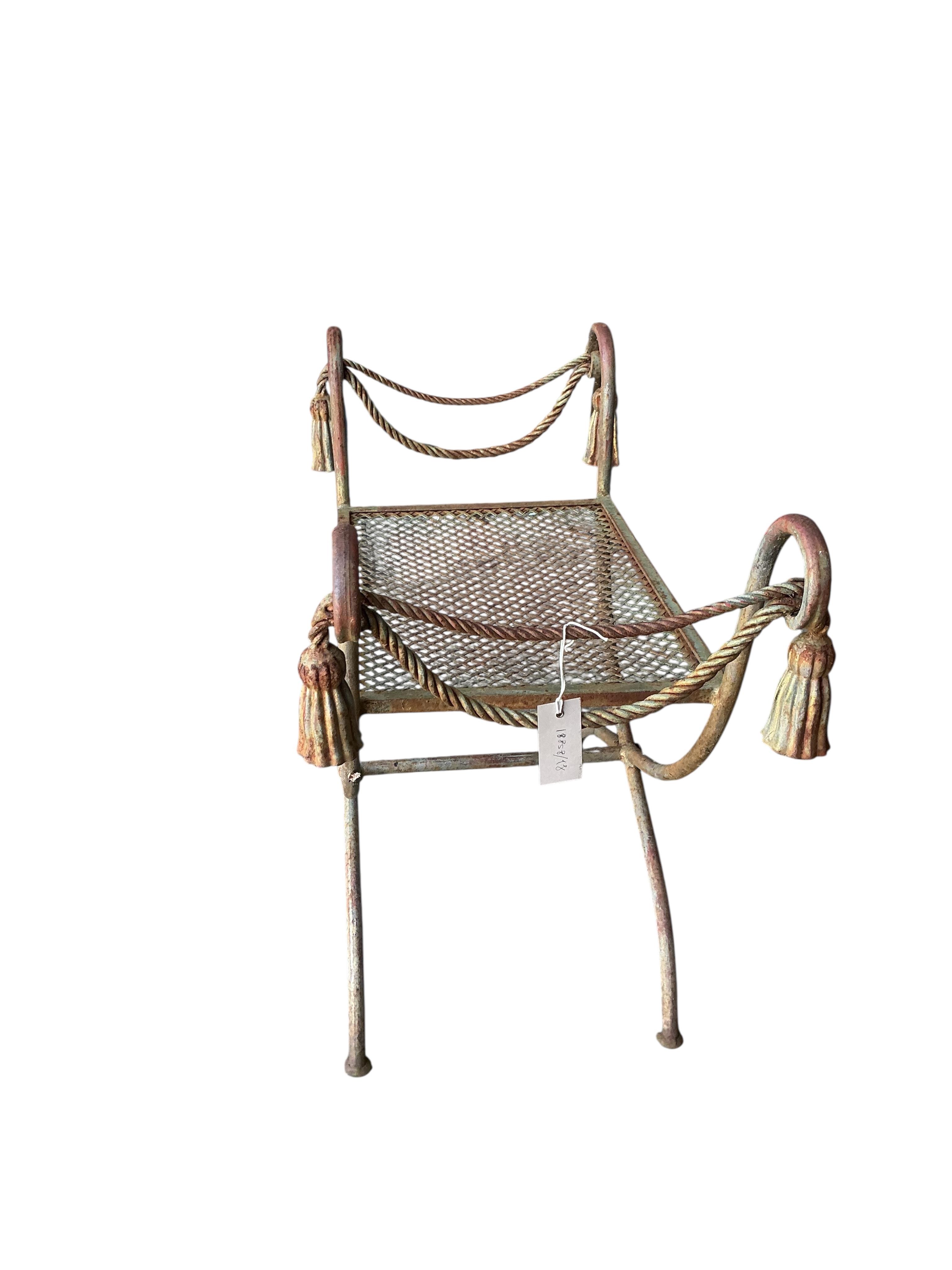 A wrought iron X-framed stool, width 71cm, depth 40cm, height 61cm